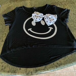 The Clas-sic Novelty Smile Black Tee With Applied Polka Dot Bow
